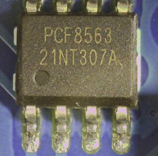 The PCF8563 chip on the breakout board as seen through a digital microscope.