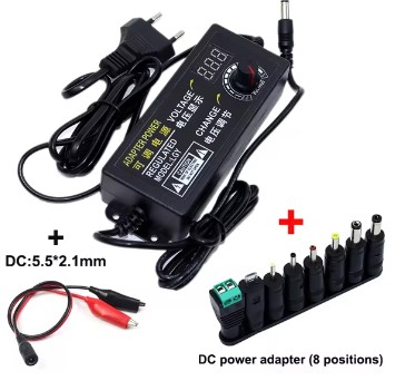 Multi-voltage AC adapter with accessory barrel adapters